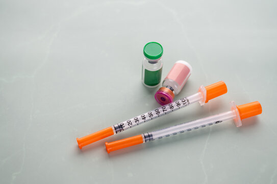 Single Use Syringes Next to Small HRT or Peptide Vials