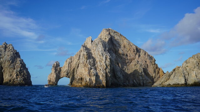 Natural rock arch formation at El Arco in Cabo San Lucas, Mexico, photographed from the ocean with clear blue skies