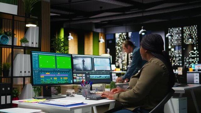 Chroma key with professional editor working in video production at agency office, doing color correction and creating a montage on dual monitors. Creative process with media tech tools. Camera A.