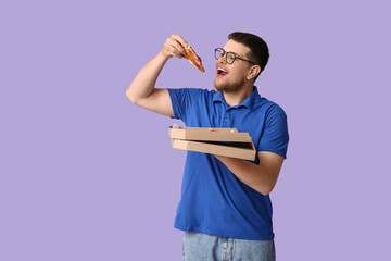 Young man eating piece of tasty pepperoni pizza on lilac background