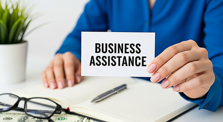 Woman presents business assistance card over notebook with pen and glasses on desk offering financial and professional support services