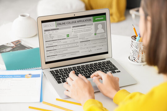 Teenage girl with approved college application on laptop at home, closeup