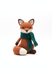 Handmade crocheted fox toy wearing a green scarf, isolated on a white background