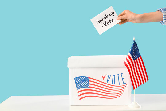 Female hand holding paper with text SPEAK UP VOTE and USA flag near ballot box on blue background