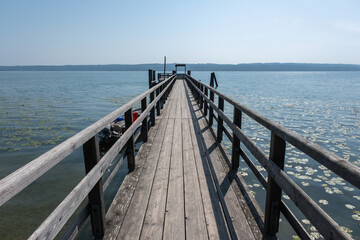 Wooden Lake Pier for Swimming and Leisure by People on Calm Water