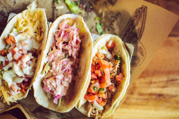 A variety of tacos served together at a Mexican food restaurant