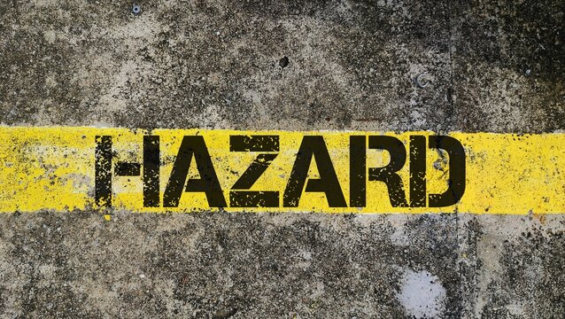 Yellow line with the word hazard. any source of potential damage, harm, or adverse health effects on a person, property, or the environment