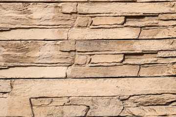 Obraz premium Texture of beige stone wall as background