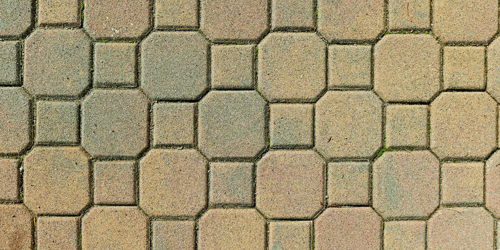 Close-up of interlocking stone tiles forming an intricate geometric pattern in muted earth tones.