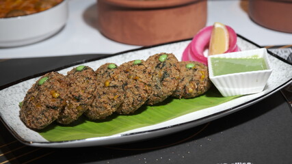 Rich Indian curry served in rustic bowl with aromatic spices and herbs – warm South Asian restaurant style comfort food