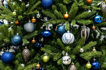 Artificial Christmas tree with silver and blue ornaments