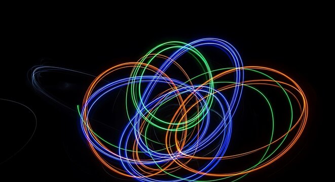 Abstract light painting with colorful circles and swirls on a black background