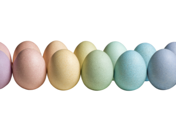 Pastel eggs in a row, softly lit, on black background