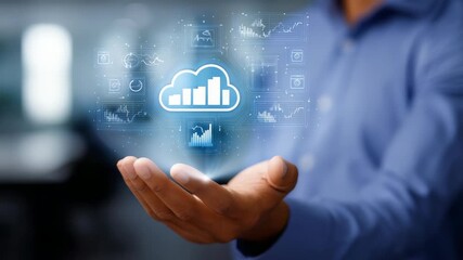 Businessman holding a digital cloud icon with futuristic data analytics and technology symbols hovering above his hand. Conceptual image representing cloud computing and digital transformation - Powered by Adobe