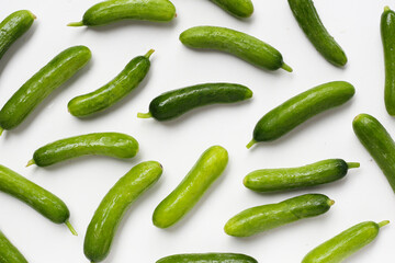 Fresh mini baby cucumbers on white background