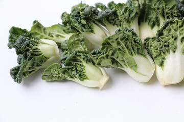 Fresh baby bok choy with crisp white green leaves.
