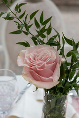 Soft pink rose centerpiece arrangement elegant wedding reception table decoration delicate petals greenery detail refined celebration decor