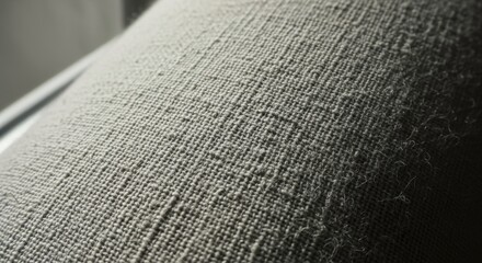 Closeup of a rough, textured woven fabric with visible threads and fibers