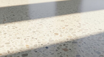 Polished concrete surface with aggregate details and a shadow cast across it
