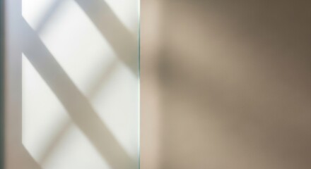 Geometric shadow patterns cast by sunlight on a wall, creating abstract shapes and lines