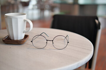 Round glasses and coffee cup on a table in a cafe