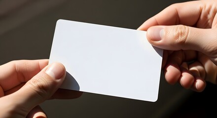 Obraz premium Blank business card being handed over in natural light for business identity mockup or design template