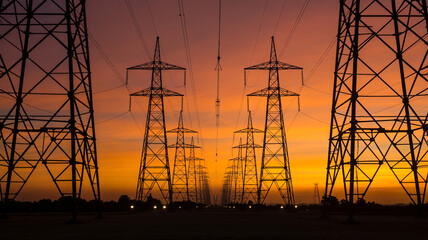 Power lines and transmission towers at sunset energy infrastructure view