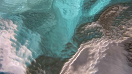 An abstract close-up of a glass surface with a flowing effect. The smooth transitions of shades...