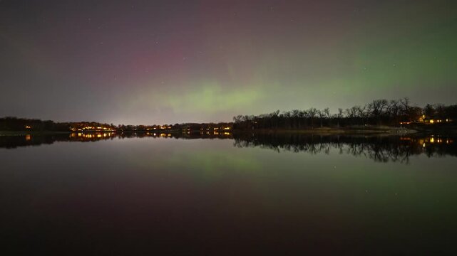 Aurora borealis is showing in clear sky over a tranquil lake, Minnesota