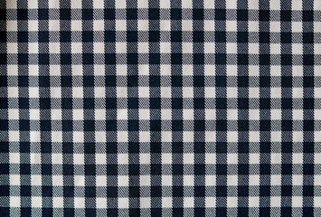 Close-up pattern of black and white gingham check fabric, often referred to as Vichy check. The textile background is suitable for home decor, kitchen themes, fashion, picnics, or a simple backdrop.