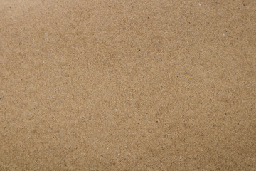 Light brown pressed board or corkboard surface. This background material offers an earthy and organic aesthetic, suitable for various design, craft or presentation themes.