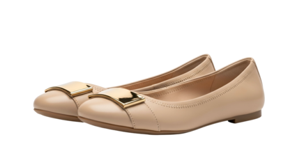 Pair of beige flat shoes featuring polished gold-toned hardware details displayed against a dark background