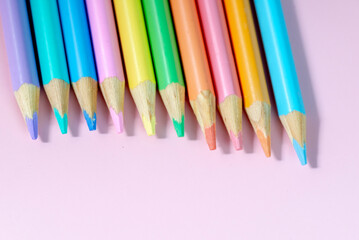 colored pencils on a pink background