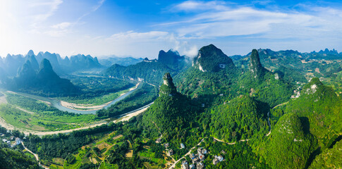 Aerial shot of the spectacular karst mountain and river with green valley landscape in Guilin