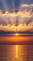 A breathtaking sunset over a calm body of water with sun rays streaming through scattered clouds, creating a serene and picturesque scene
