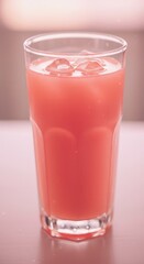 Tall glass filled with chilled pink beverage rests upon a subtle surface