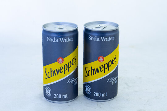 Johannesburg, South Africa - two cans of Schweppes soda water isolated on a clear background with copy space