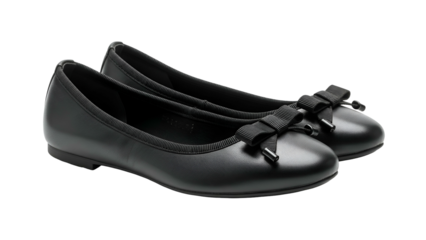 Pair of classic black flat shoes with decorative bows displayed against a dark background