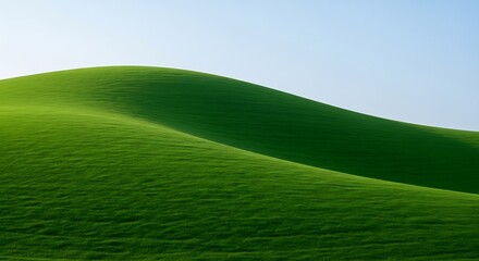 Rolling green hills under a clear blue sky, creating a peaceful and serene landscape perfect for backgrounds, wallpapers, or naturethemed designs