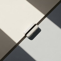 Close-up shot of a white security sensor placed on a surface with shadows.