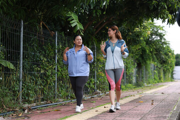 Slim and Plus size woman with sport jacket walk exercise outdoor, wellness lifestyle, wellness and healthy lifestyle