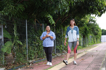 Slim and Plus size woman with sport jacket walk exercise outdoor, wellness lifestyle, wellness and healthy lifestyle
