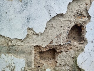 Close up of Damaged Exterior Wall with Flaking White Paint