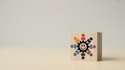 Teamwork and collaboration represented on a wooden block with smiling gear face