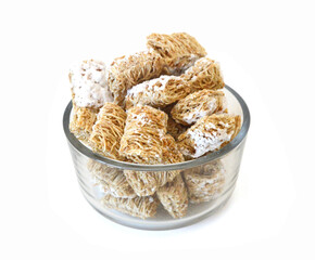 Breakfast setting with frosted wheat cereal on white background 
