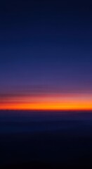 Obraz premium Serene evening twilight sky with deep indigo and vibrant orange hues, casting atmospheric shadows across a vast, peaceful landscape scene, gradient, dramatic, environment