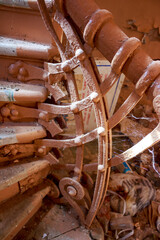 Ornate, dusty Art Nouveau banister in a dilapidated manor. Cobwebs cling to the forgotten details, hinting at past elegance and decay