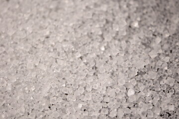 Close-up of the surface of white salt grains, macro salt