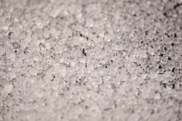 Close-up of the surface of white salt grains, macro salt