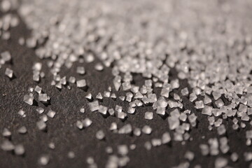 Close-up of the surface of white salt grains, macro salt